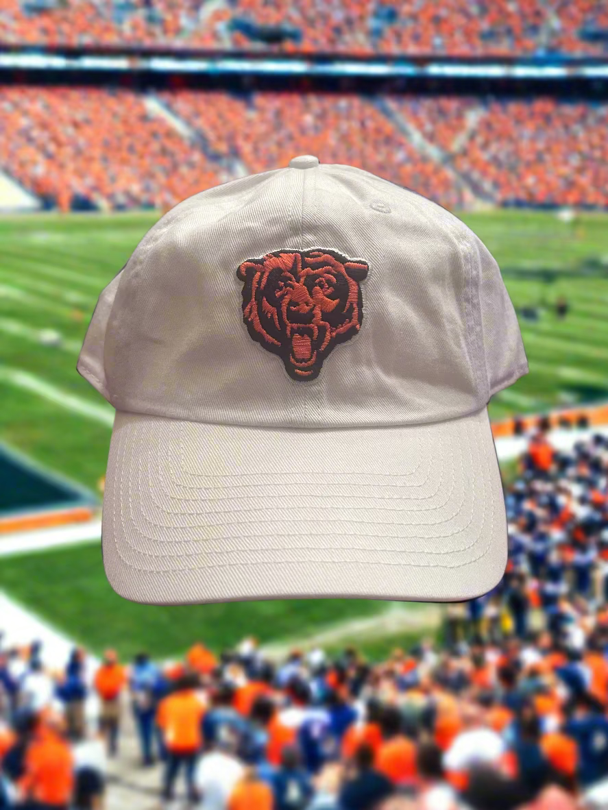 Beige cap with a bear logo in front of a football stadium