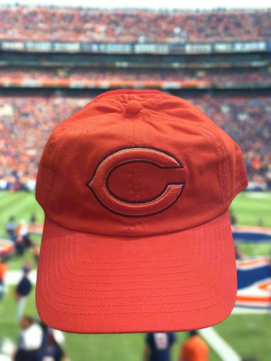 Red cap with a logo on a football field
