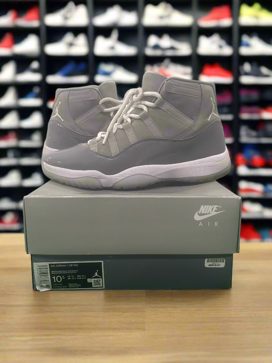 Gray high-top sneakers on a Nike box with a white background