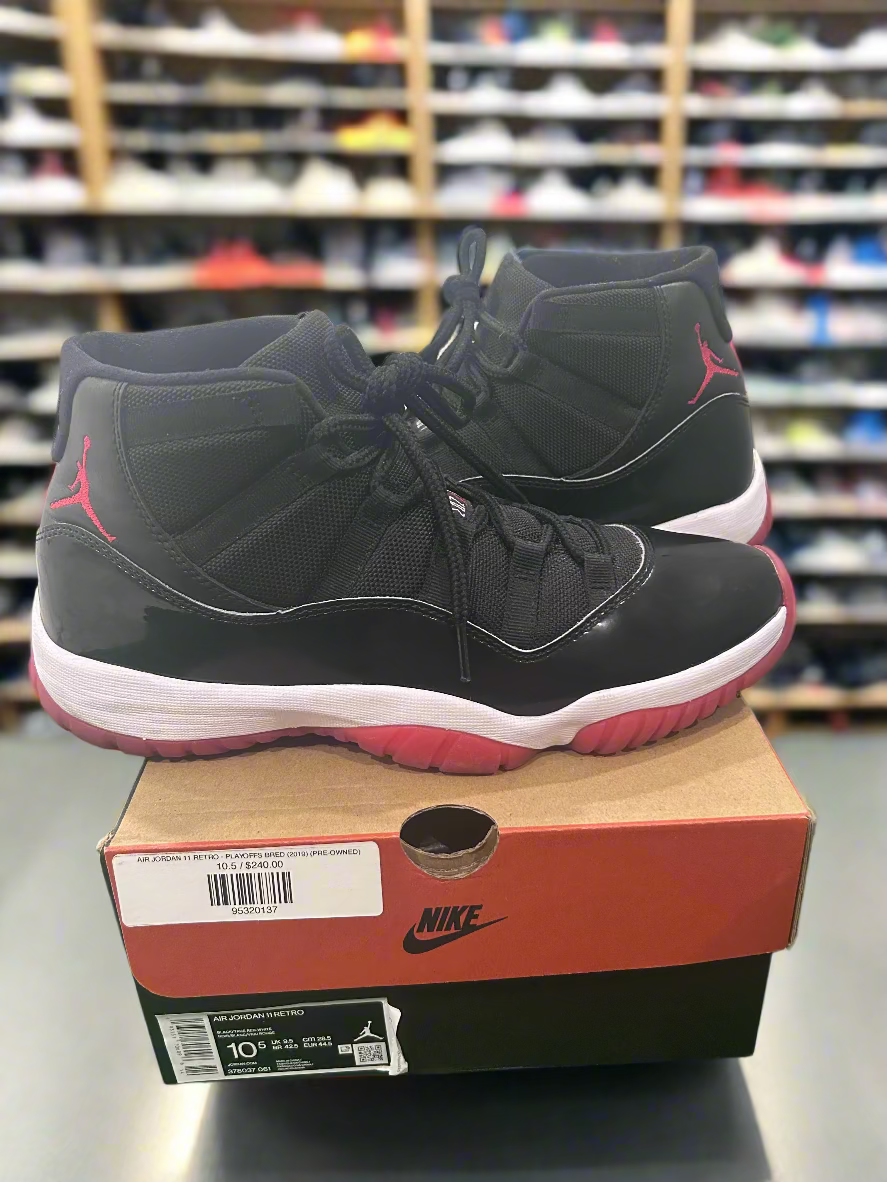 Black and red high-top sneakers on a Nike box with a store shelf in the background