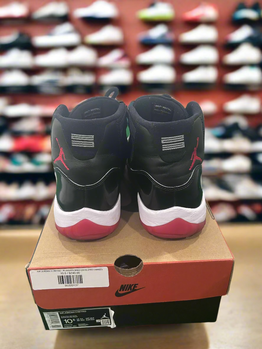 Black and red sneakers on a Nike box with a white wall background