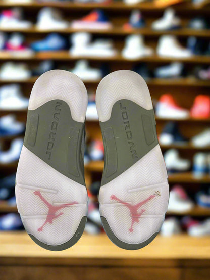 Close-up of Jordan brand shoes with a blurred shoe rack in the background