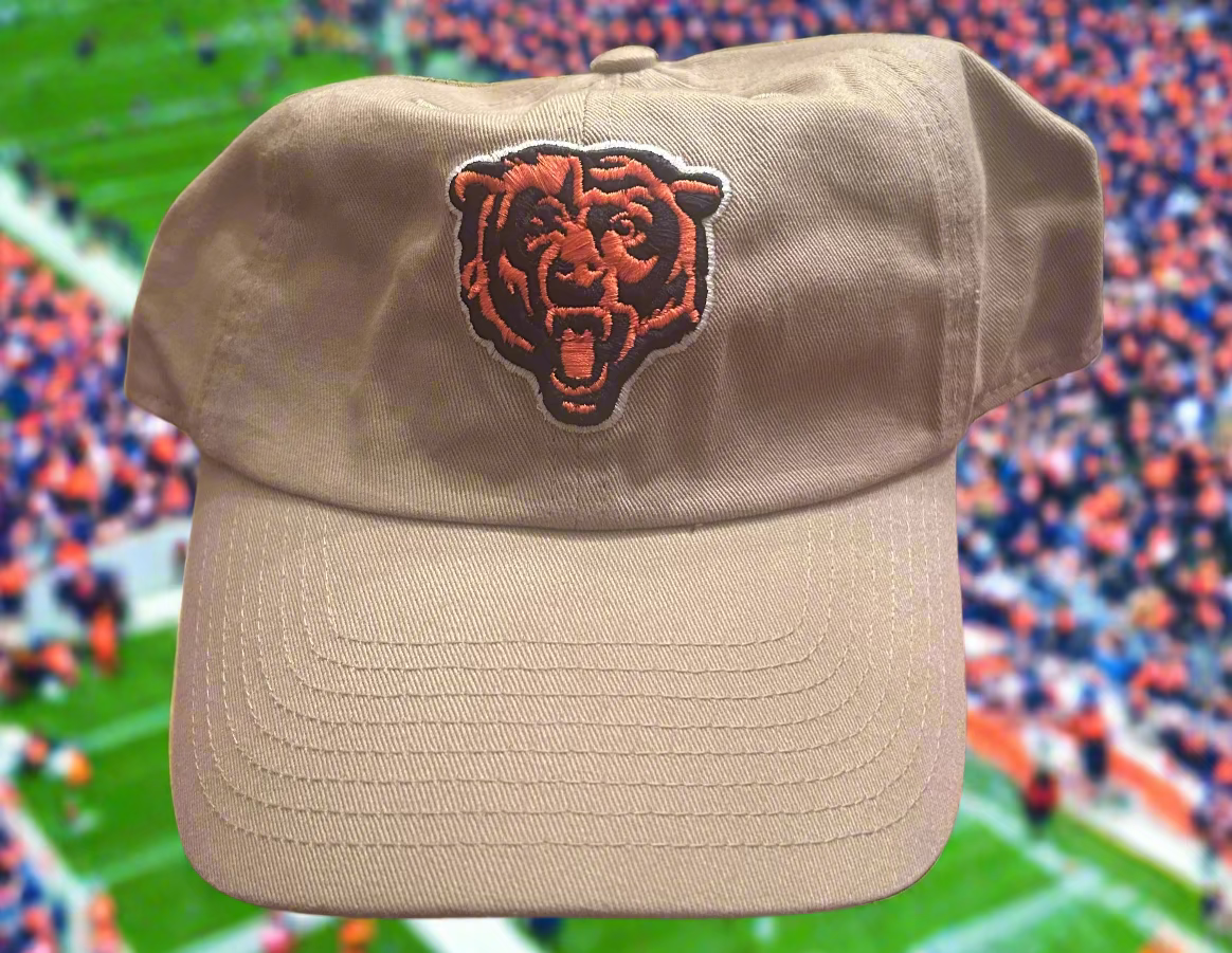 Beige cap with a logo on a sports stadium background