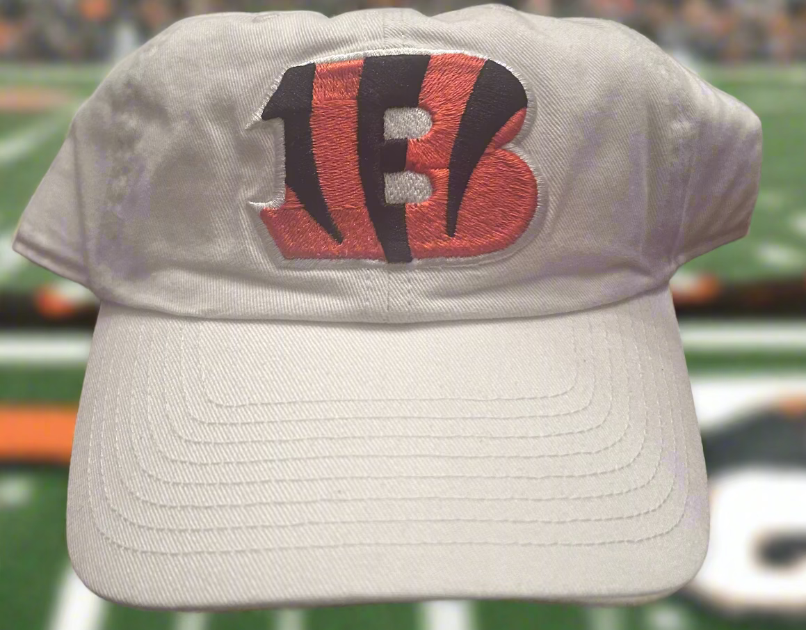 Beige cap with a logo on a sports field background