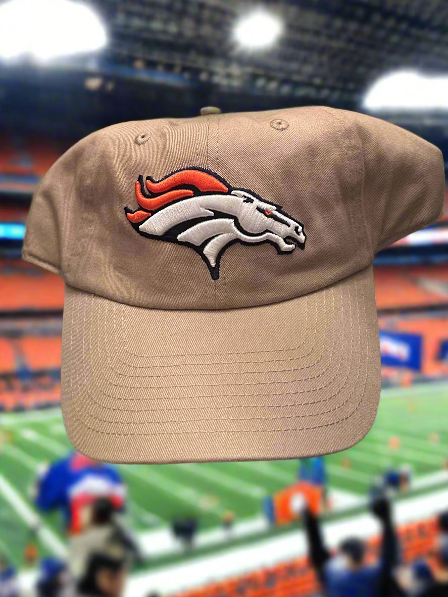 Beige cap with Denver Broncos logo on a blurred stadium background