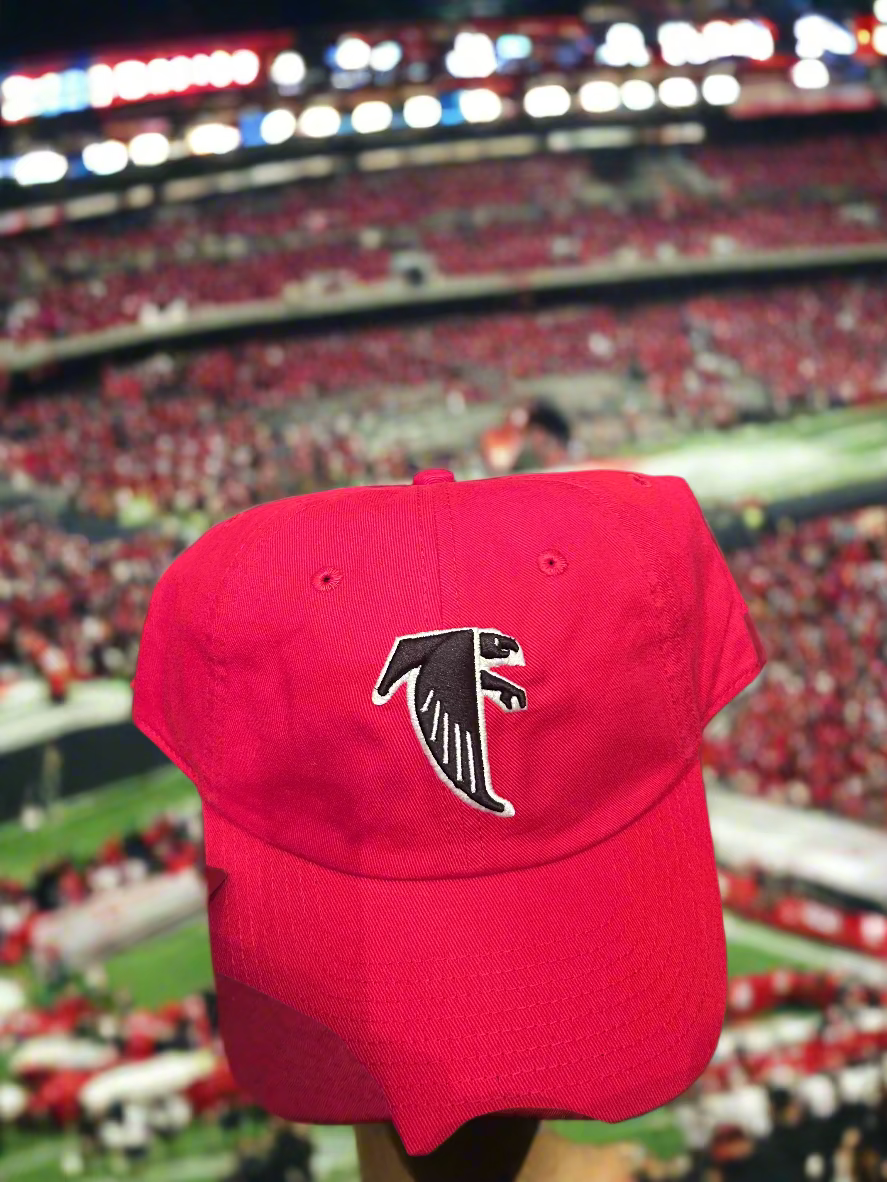 Red cap with a black logo on a wooden surface