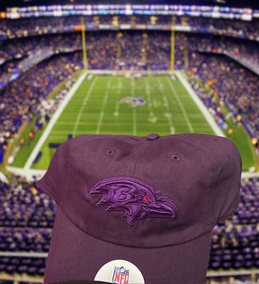 Purple cap with a logo on a wooden surface